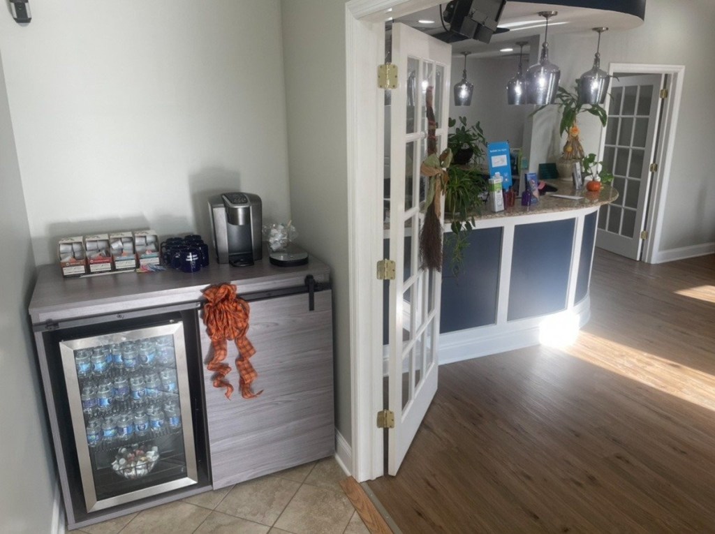 Mini fridge and bar next to front desk